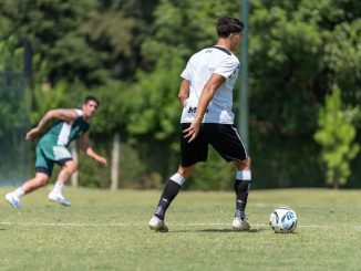 Athletes in action during a soccer training session outdoors on a sunny day.
