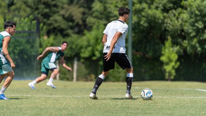 Athletes in action during a soccer training session outdoors on a sunny day.